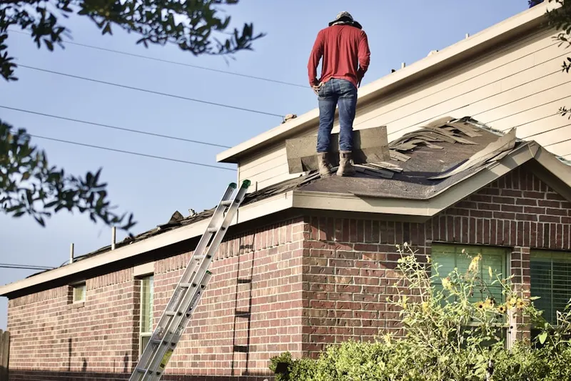 Professional roofer working on a residential roof in Blackstone